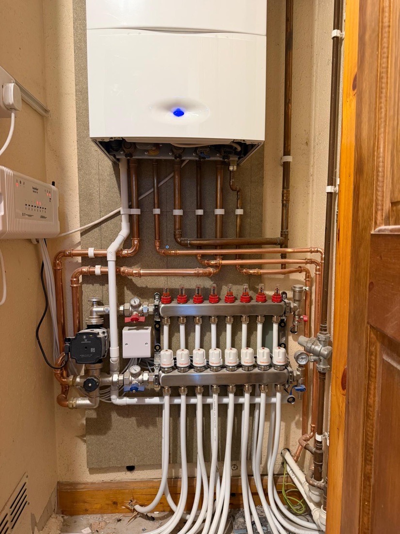 An eight zone underfloor heating manifold with numbered, colour coded circuits